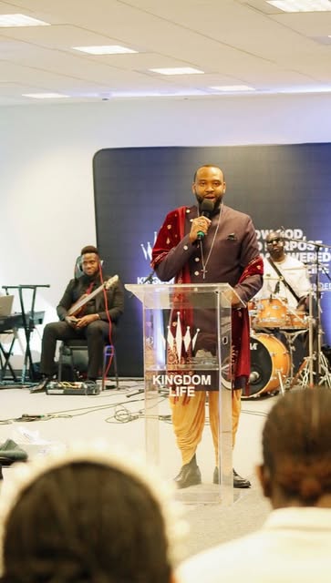 Pastor teaching with the worship band
