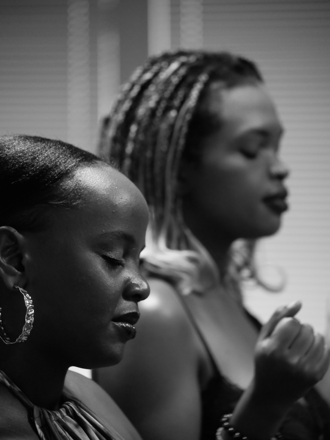 Two women worshiping during the service