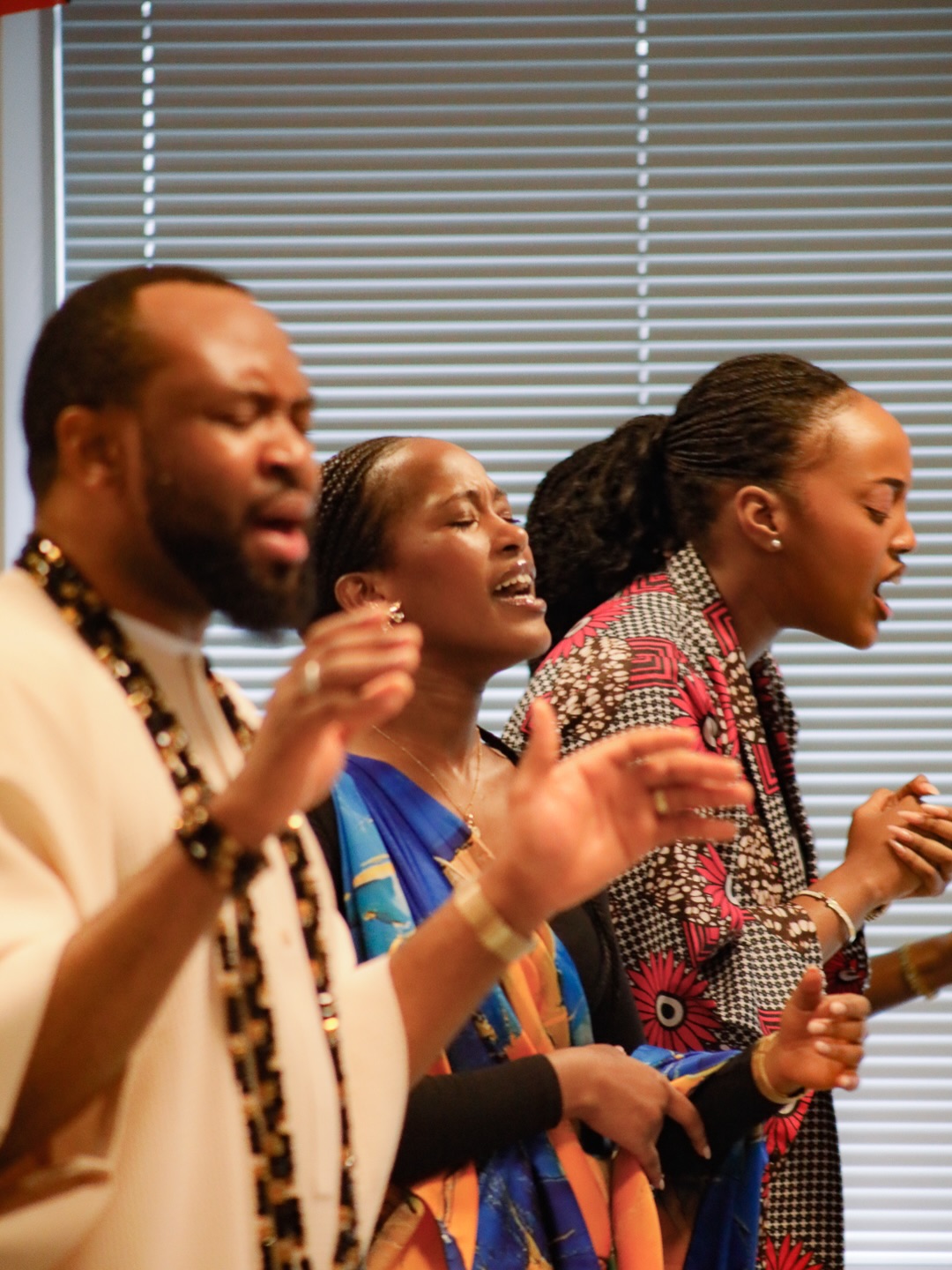 Three people singing in worship