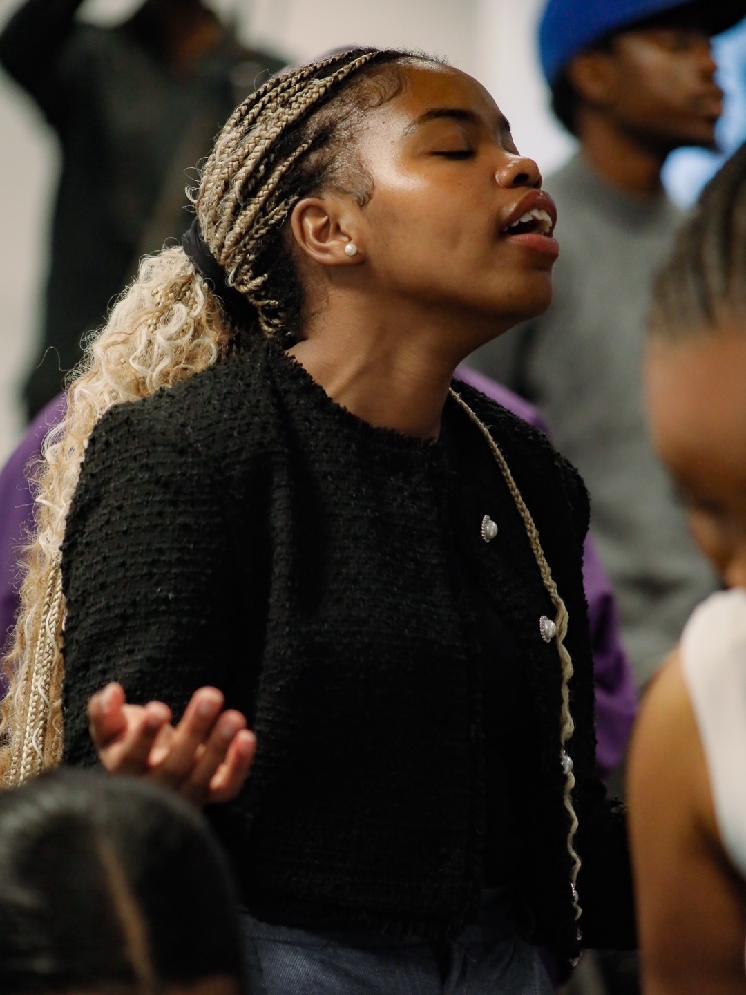 A young woman worshiping in the congregation