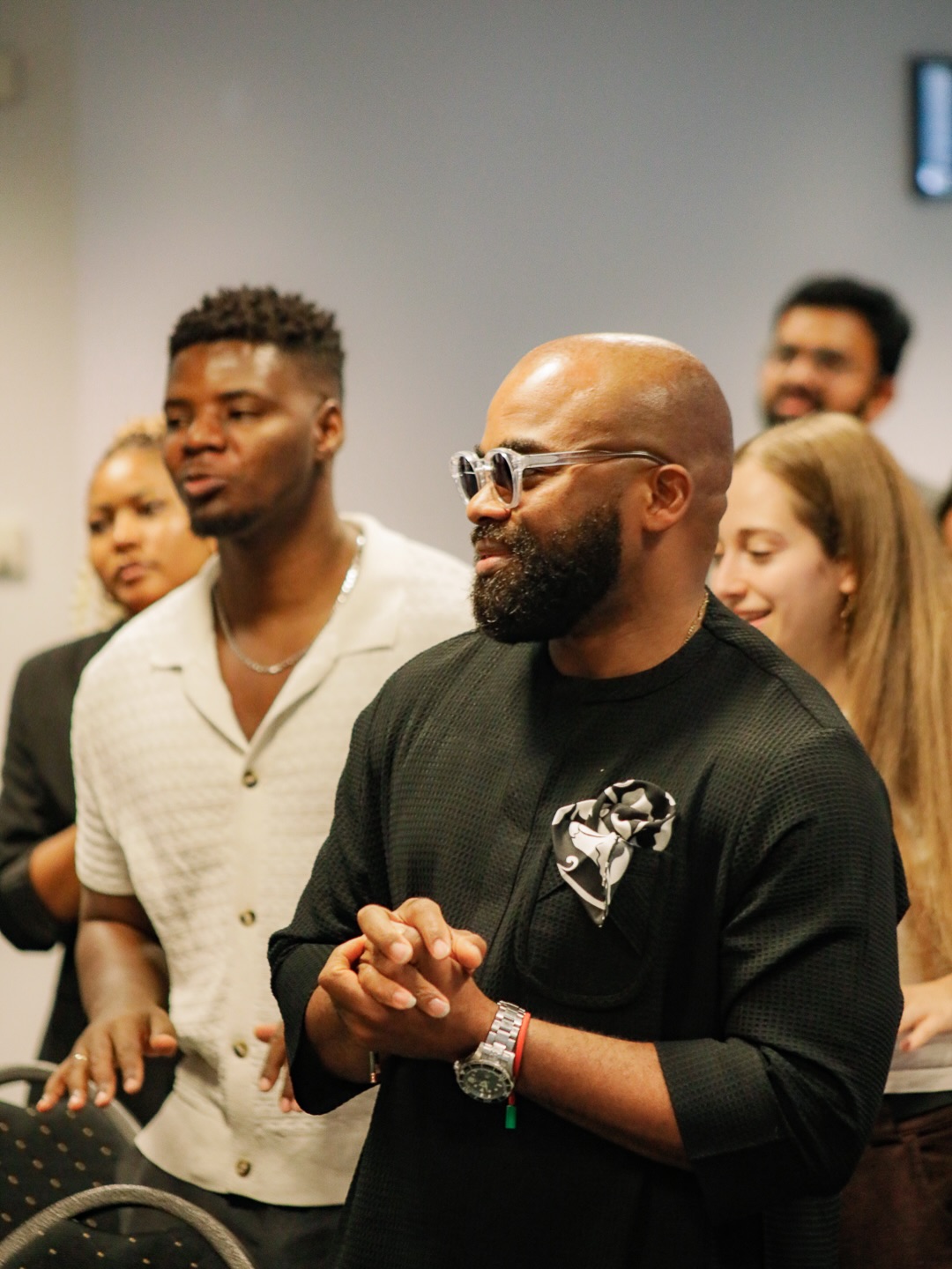 Men standing together during worship